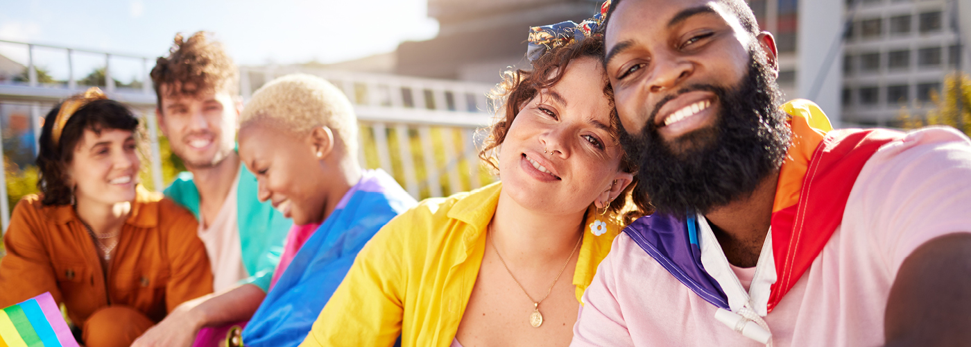 AIZ-17207-0823-Assurant ERG Pages-PRIDE-1400x500 a group of people smiling