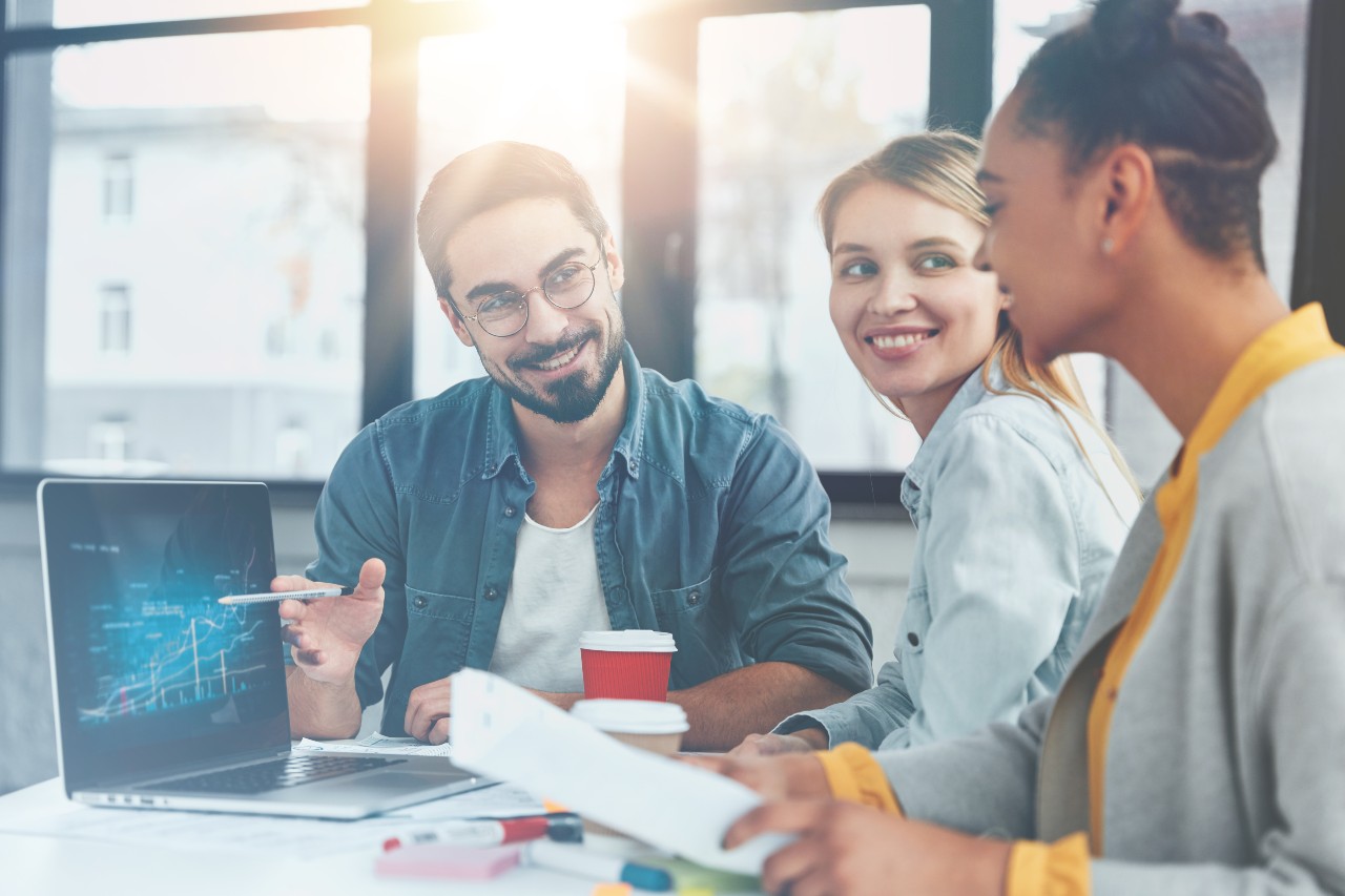 Assurant Careers a few people looking at a laptop